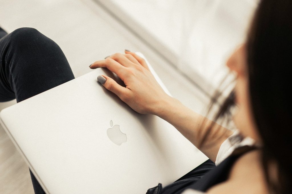 woman on airplane with macbook